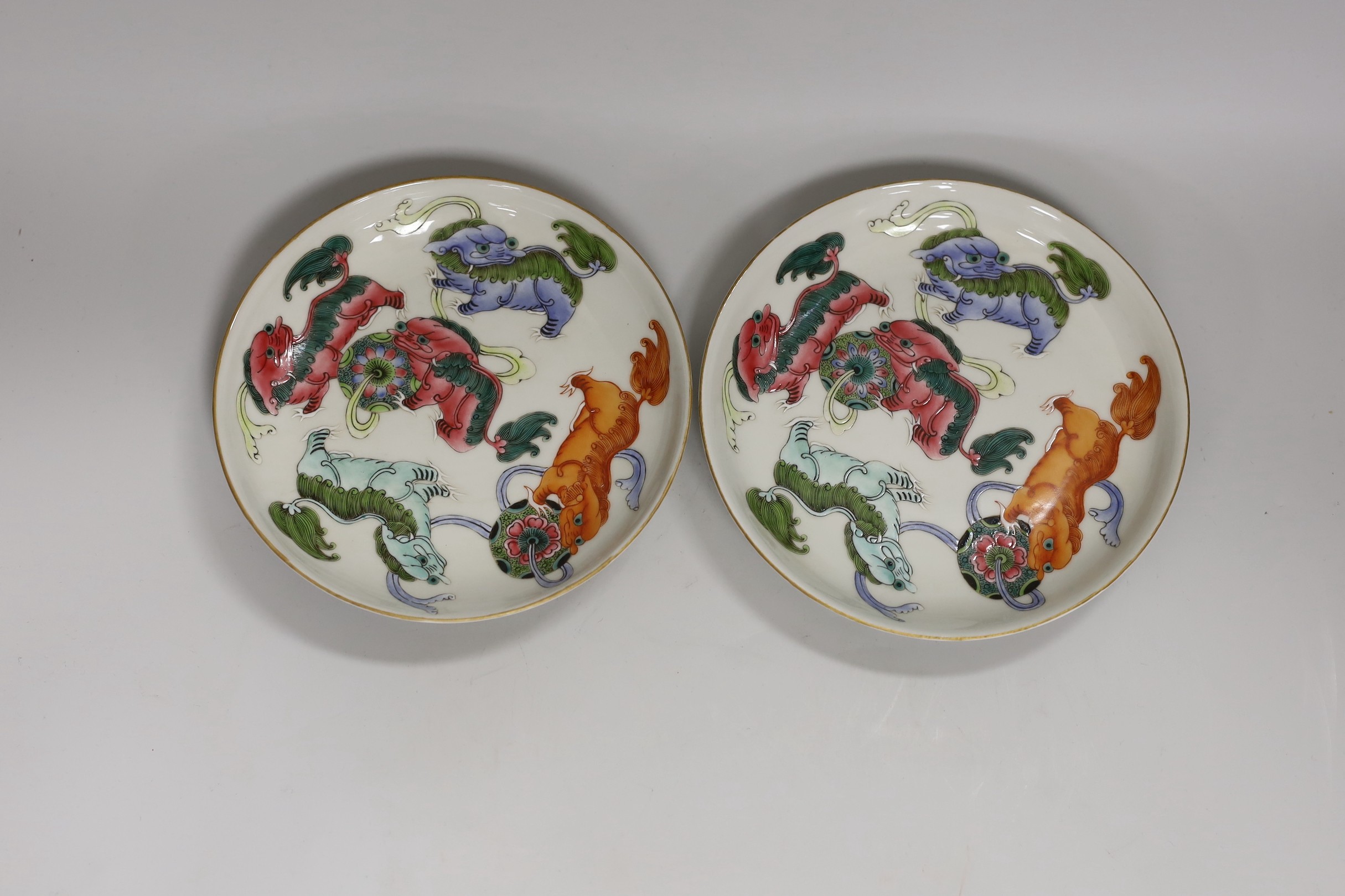 A pair of Chinese famille rose bowls and two similar saucer dishes